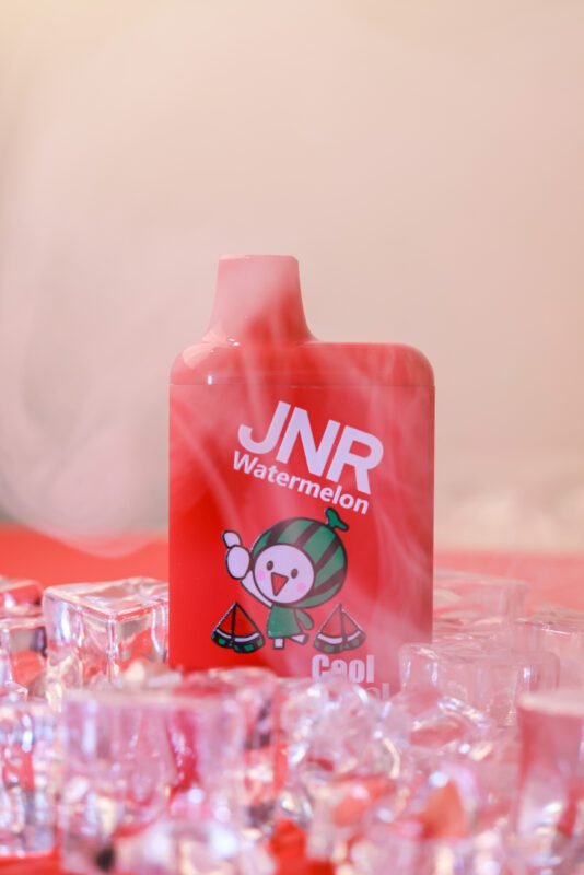 JNR Cool Casual vape in red Watermelon flavor surrounded by ice cubes and mist
