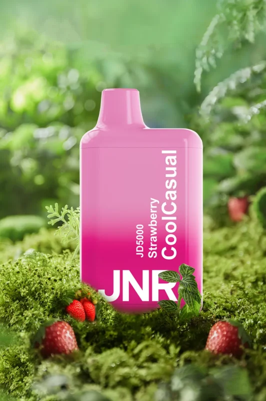 JNR JD5000 Cool Casual vape in pink with strawberry flavor surrounded by mint leaves on moss background