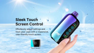 Person holding JNR Flex Ice vape with touch screen in a water-themed setting