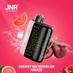JNR PLUS-X disposable vape in Cherry Watermelon Freeze flavor, featuring a pink and black design surrounded by fresh cherries, watermelon slices, ice cube, and water splashes
