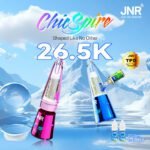 JNR ChicSpire 26.5K Puffs Vapes in pink and blue with TPD certified badge, refill bottles, and mountain background featuring the slogan “Shaped Like No Other”